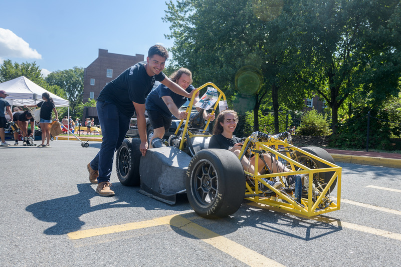 Students in the Society of Automotive Engineers showcase their Formula SAE car at the Involvement Fair