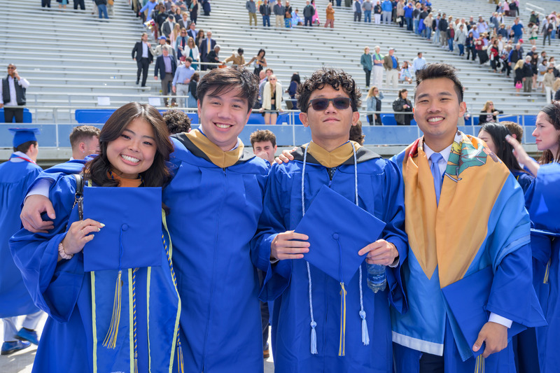 Congratulations Class of 2025! A group of graduates enjoy commencement with their classmates.
