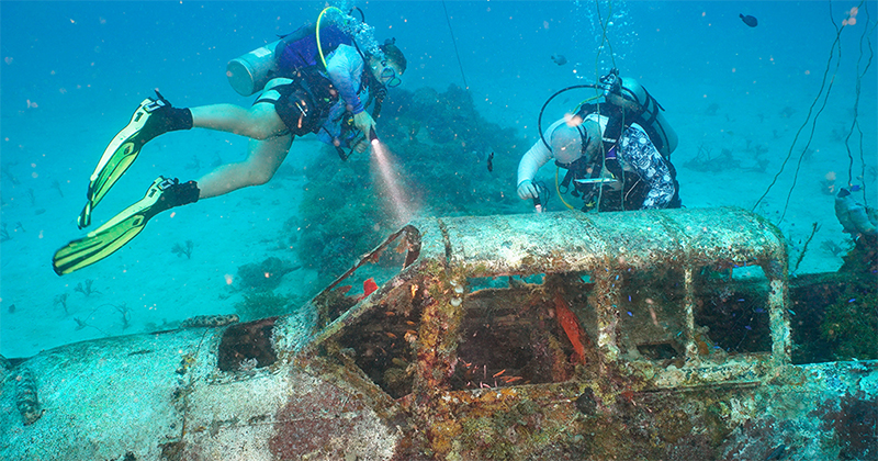 Evan McArdle, pictured (right), is spending part of his summer on a Study Abroad program to Micronesia with Project Recover, the nation’s foremost citizen-led, nonprofit organization to search, locate, document, recover and repatriate the more than 81,500 American service members missing in action. McArdle is pictured here with Sibyl Roosen (left), a UD student studying mechanical engineering, investigating a Nakajima B6N that was found on the Project Recover mission. Evan McArdle, pictured (right), is spending part of his summer on a Study Abroad program to Micronesia with Project Recover, the nation’s foremost citizen-led, nonprofit organization to search, locate, document, recover and repatriate the more than 81,500 American service members missing in action. McArdle is pictured here with Sibyl Roosen (left), a UD student studying mechanical engineering, investigating a Nakajima B6N that was found on the Project Recover mission.