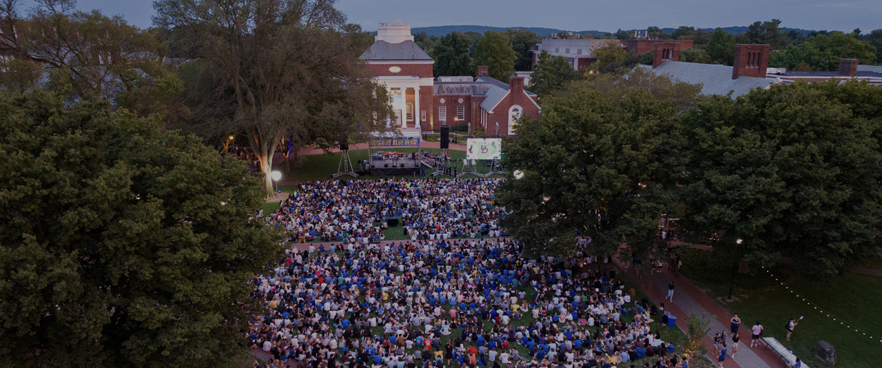 aerial view of students gathered on The Green at dusk in front of Memorial Hall for the Twilight Induction Ceremony