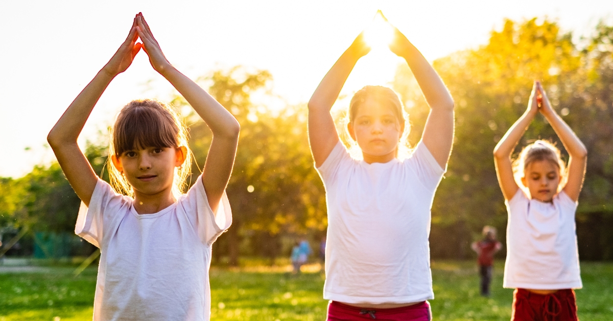 Three young girls in a Yoga pose