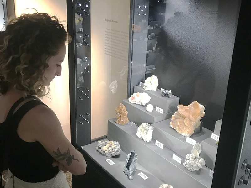 Student examining specimens in Mineralogical Museum