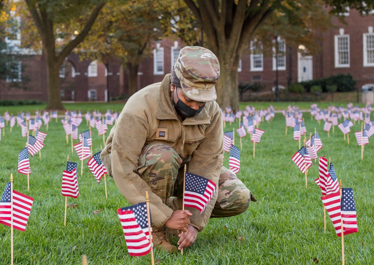 Student veteran plants a small flag on The Green