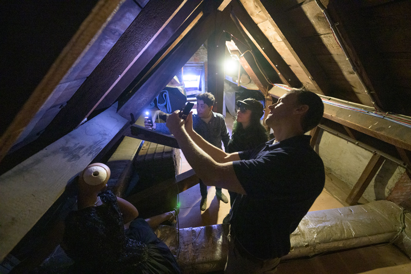 In the museum’s attic, team members (from left) Margalit Schindler, Morrigan Kelley and Tim Leefeldt check out the condition of some wooden beams.