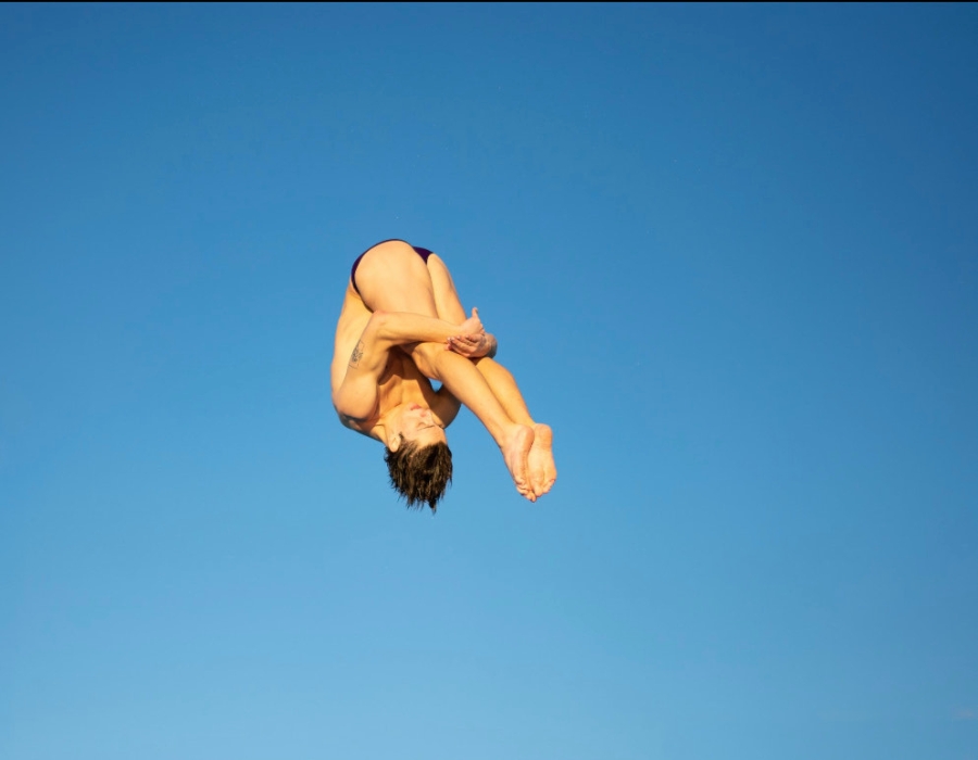 philip_townsend_canr_student_athletes_2024 - 2 Philip Townsend in the middle of a high dive. Only sky is behind him.
