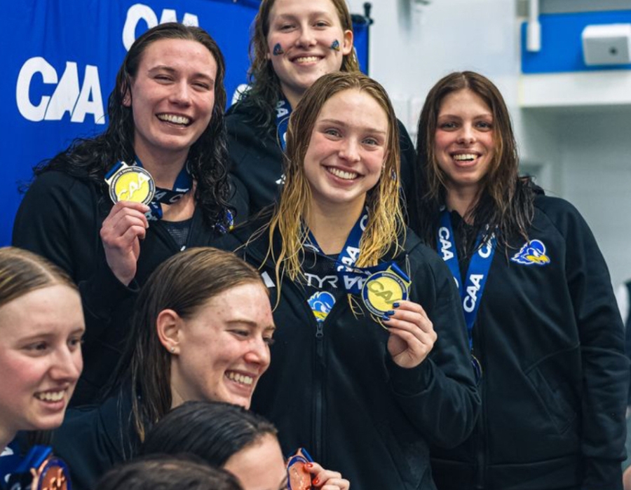olivia_willemsen_canr_student_athletes_2024 - 3 Olivia Willemsen (center) posing with her swim team.