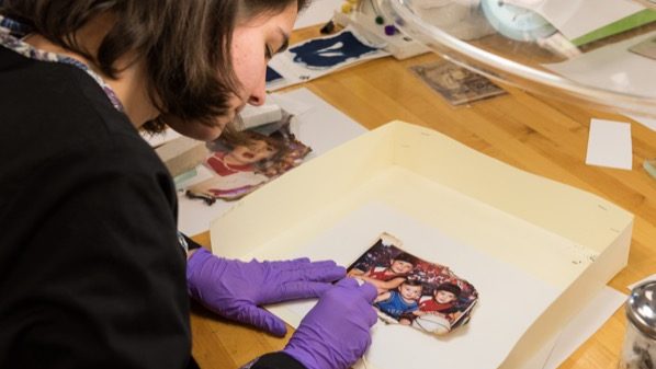 WUDPAC-Harris_Family_Photo_Preservation Student restoring family photos burned in a fire
