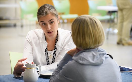 Lauren Fair, Winterthur Museum’s Head of Objects Conservation and Assistant Director of Conservation and WUDPAC Affiliated Associate Professor, discusses a ceramic pitcher with a visitor.  Two women talking to each other