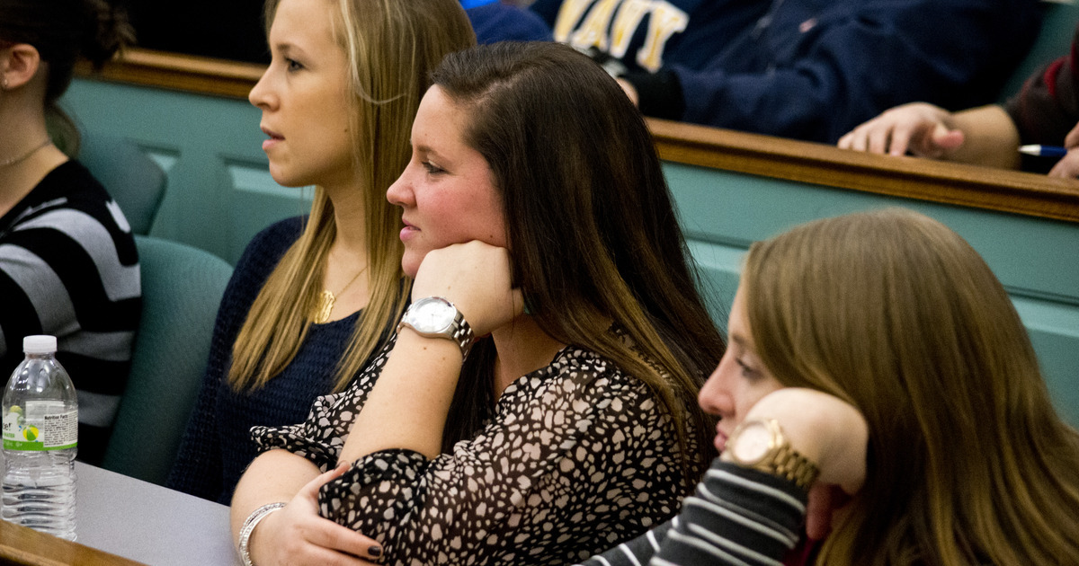 Professor Miller-Dugan during her evening of poetry Students listening attentively in a lecture hall