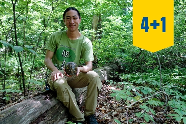 A student holding a turtle shell.