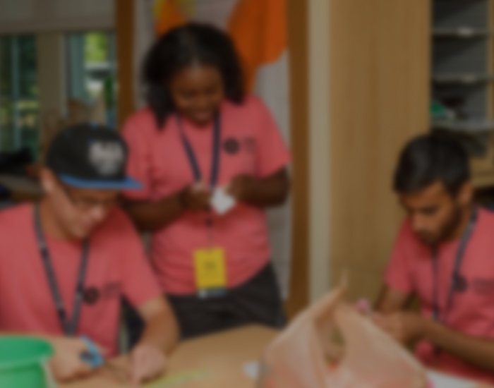 students work on crafts at a table in a Gilbert residence hall