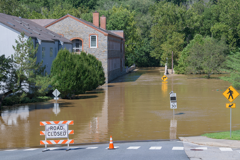 Flooded street with street signs under water