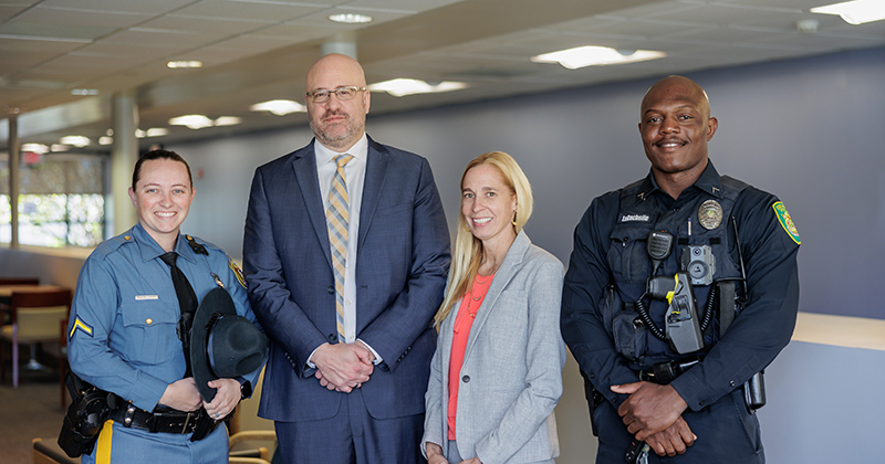 two police officers and two leaders at a training session