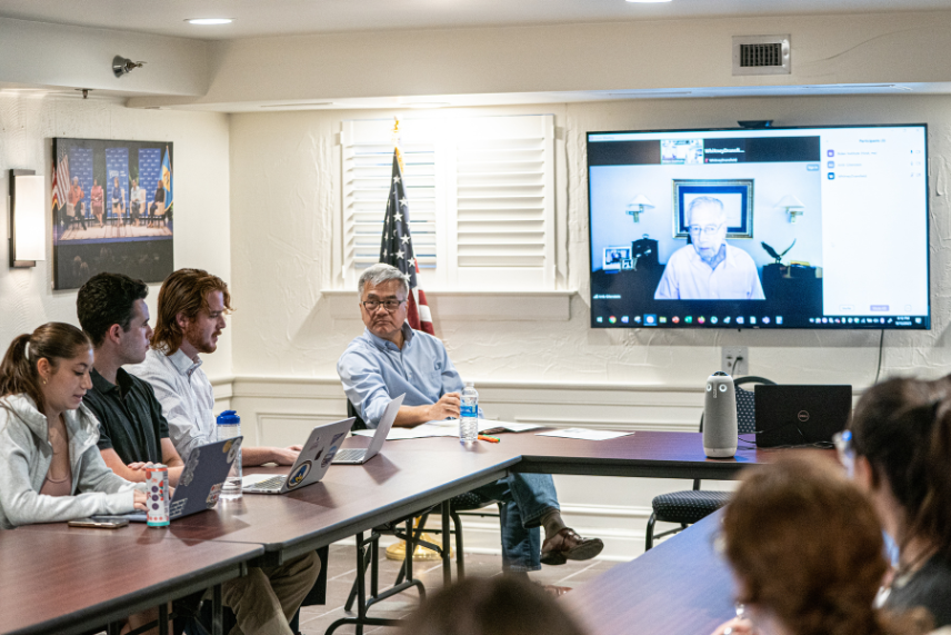 Photo of former U.S. Secretary of Commerce Gary Locke conversing with students during a Biden Institute education policy seminar