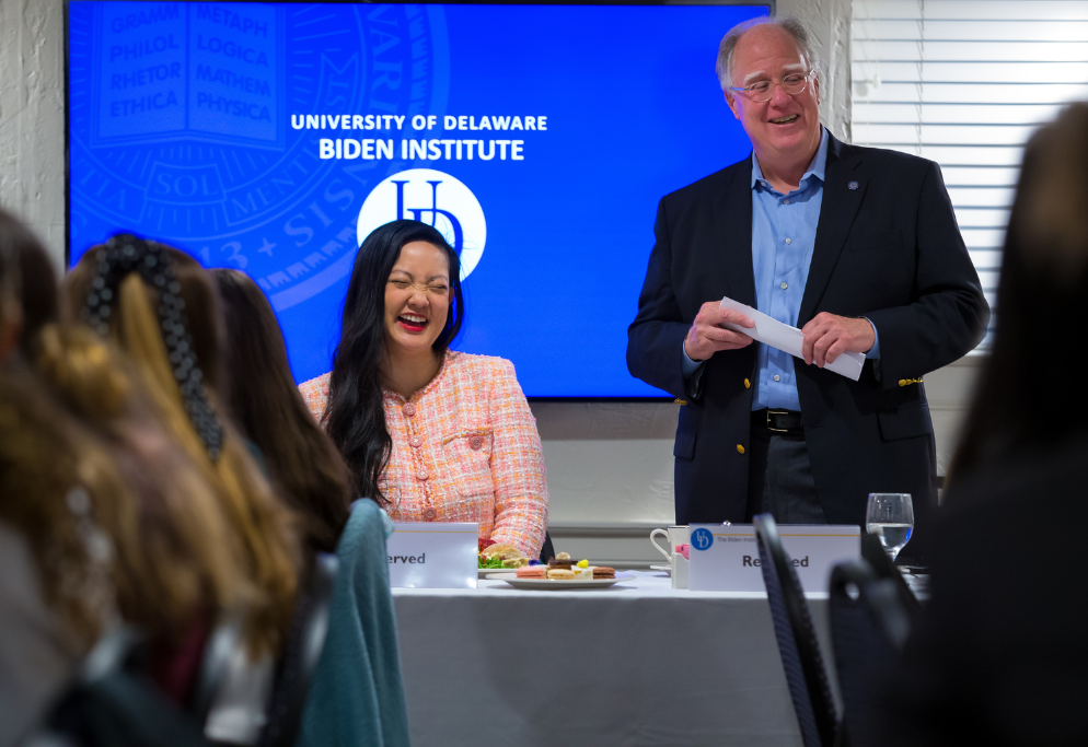 Photo of civil rights organization Rise founder and CEO Amanda Nguyen conversing with attendees at a Biden Institute policy dinner 