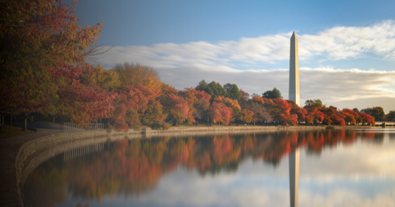 Constitution Gardens in Washington, DC, on a colorful fall day with the Washington Monument in the distance.