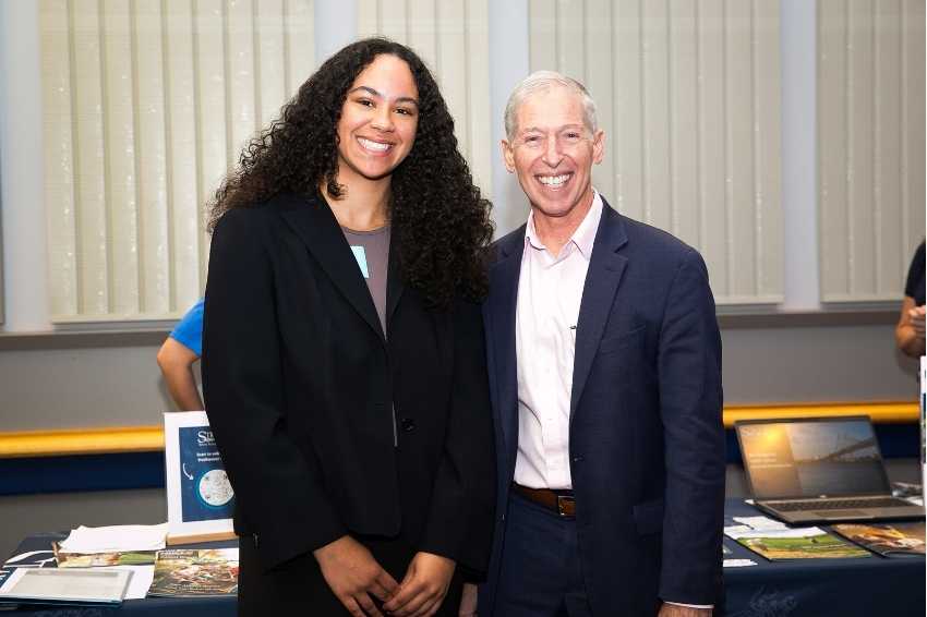 Dean Farkas poses with an attendee.