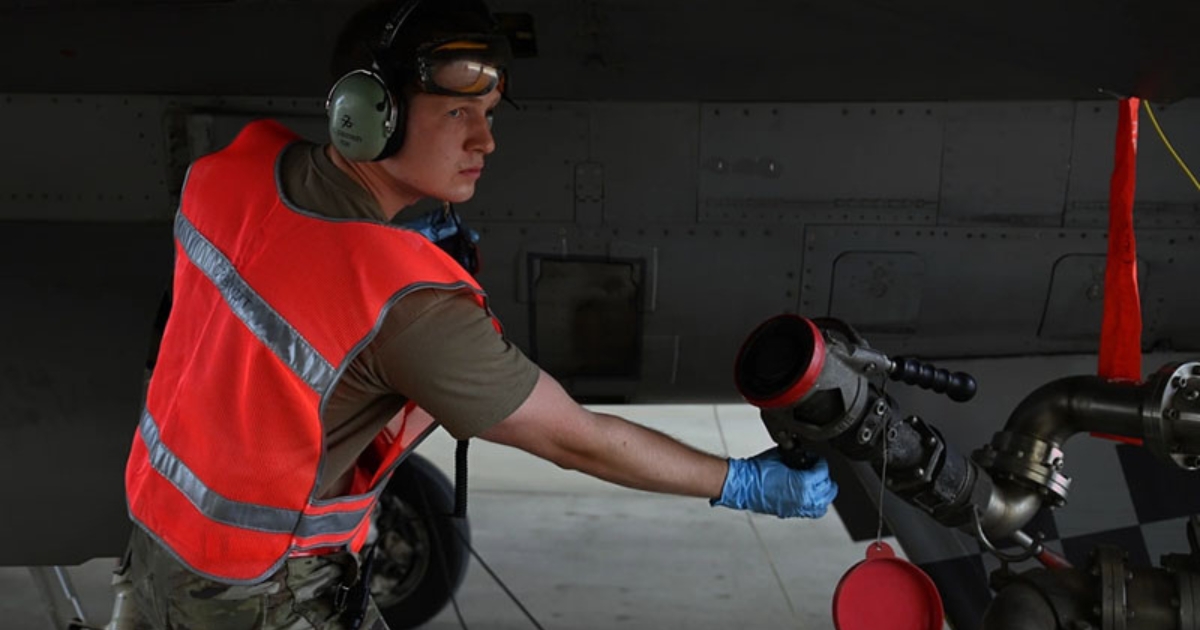 A young man working on military equipment.