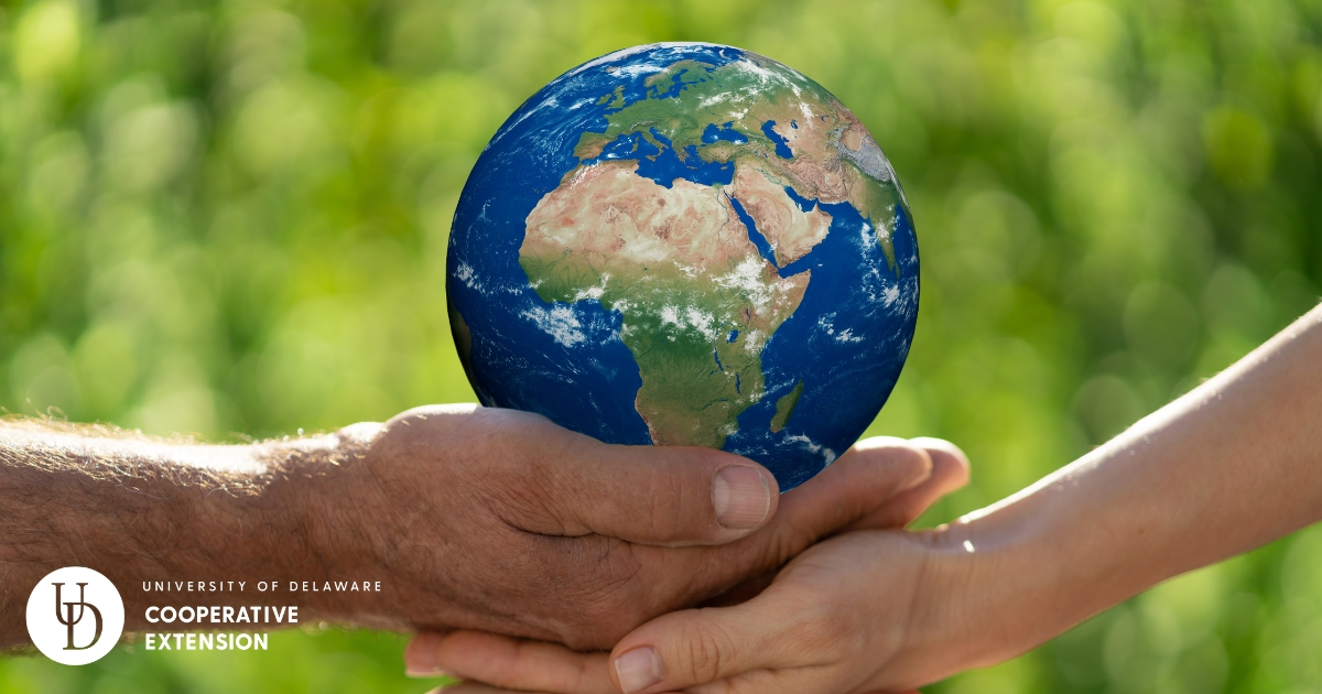people holding a model of the earth people holding a model of the earth