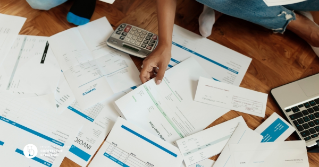 A pile of bills scattered on a table