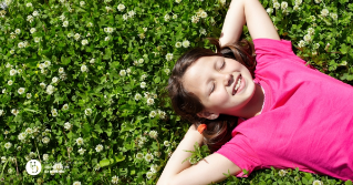 A child laying in the grass relaxing