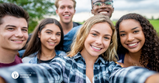 A group of teens together smiling