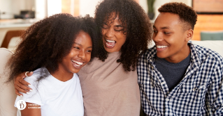 A mother with her arms around her two teens