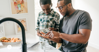 A father helping his son sort out his money