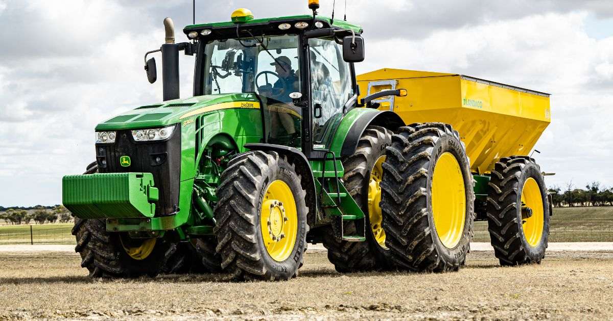 A tractor in a field planting corn A tractor in a field planting corn