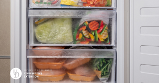 An open freezer full of stored food