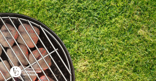 A view of a top of a grill overtop of turf