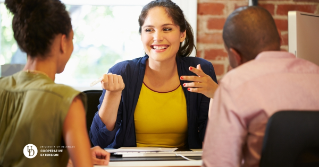 A female financial advisor talking with a couple