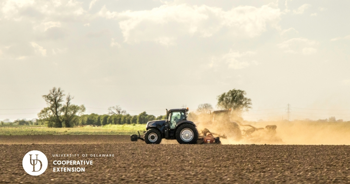 A field with a tractor applying lime A field with a tractor applying lime