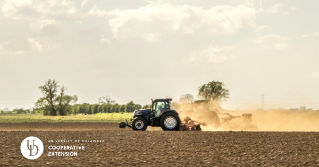 A field with a tractor applying lime