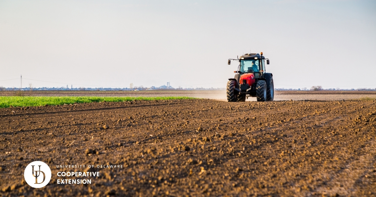 A tractor applying nutrients to a field A tractor applying nutrients to a field