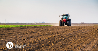 A tractor applying nutrients to a field