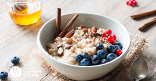 a photo of oatmeal with a variety of fruits overtop