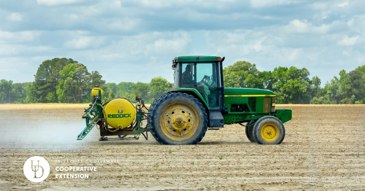A tractor applying nutrients to a field A tractor applying nutrients to a field
