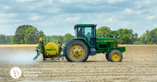 A tractor applying nutrients to a field