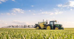 A tractor spraying a substance in the field