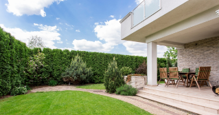 an outdoor patio with a backyard landscape