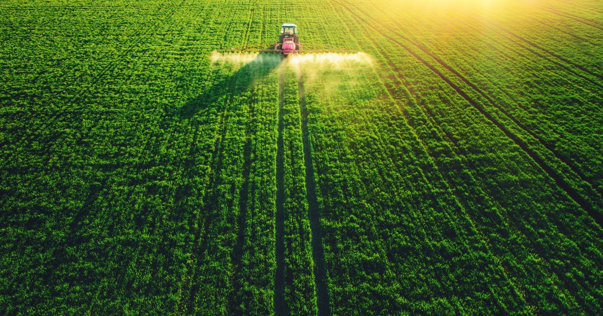 A tractor spraying crops A tractor spraying crops