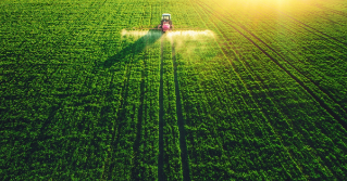 A tractor spraying crops