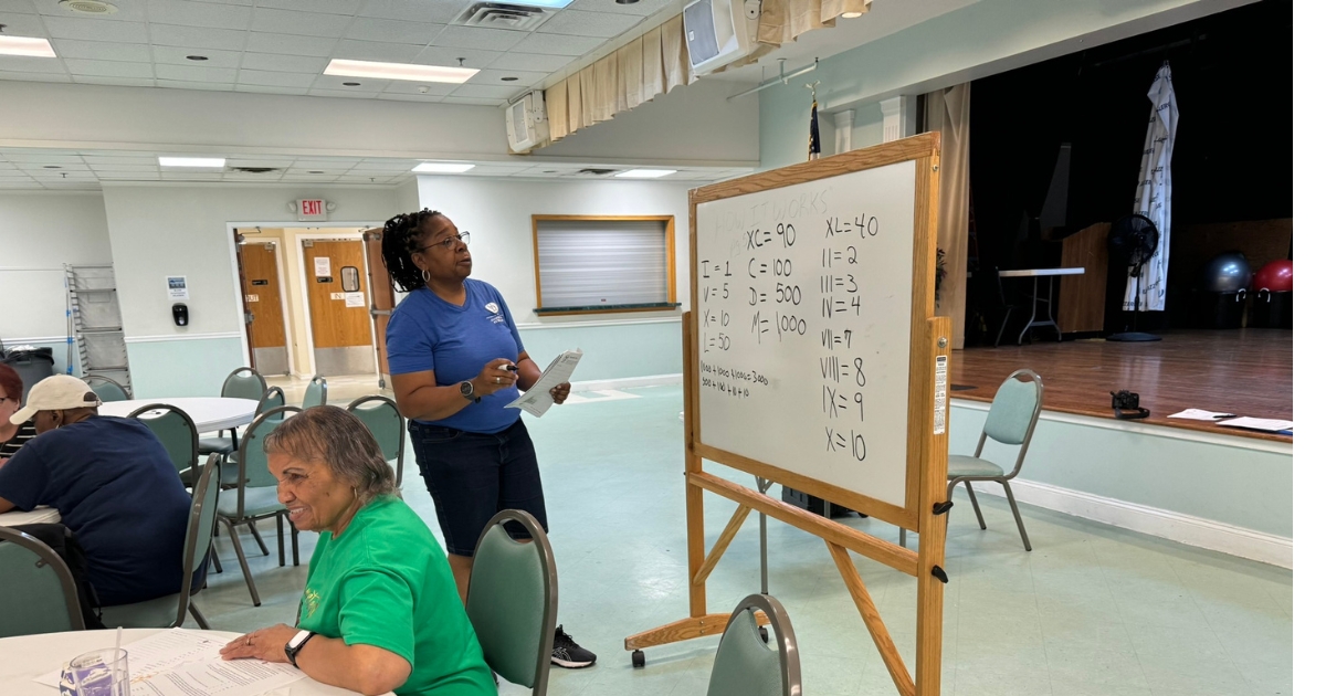 The leader reading from the white board