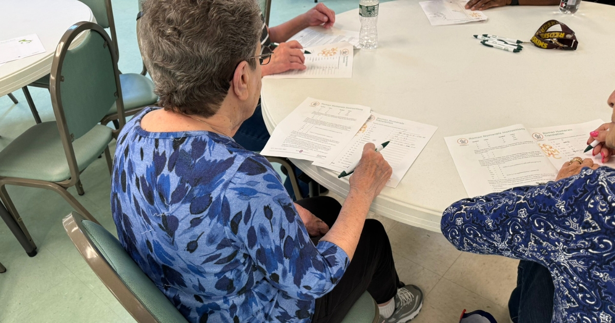 A participant writing and collaborating with others