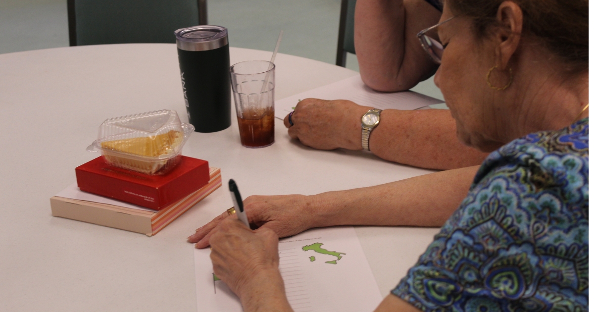 a close view of a participant writing her answers on the paper