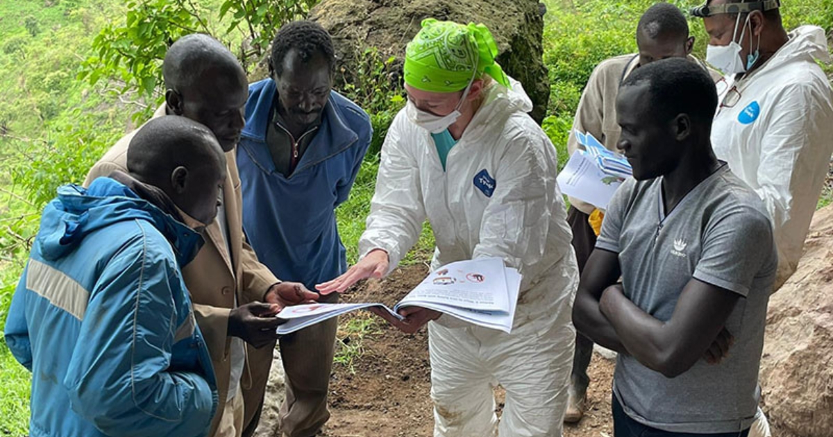 Kading reviews educational materials with local community members in Uganda.