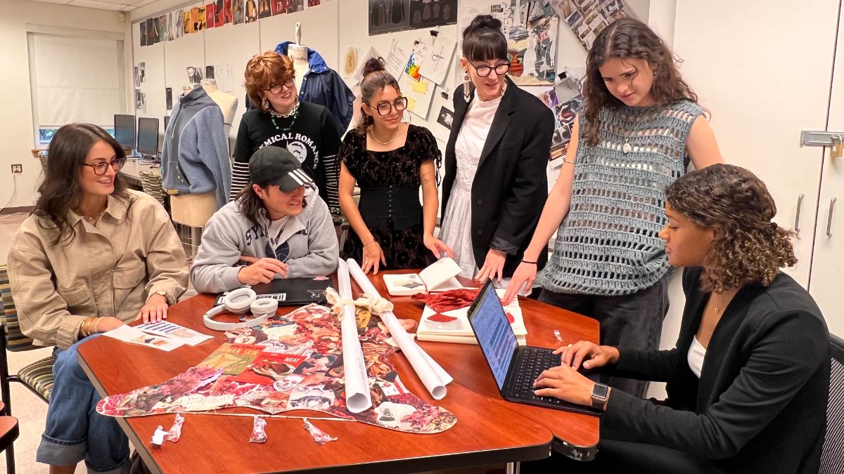 Fashion students gathered around table