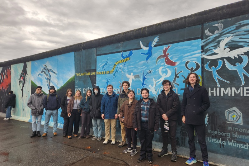 Group of UD students standing along mural wall in Germany