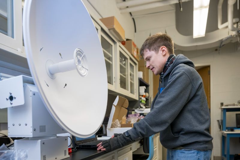 Student working on a satellite